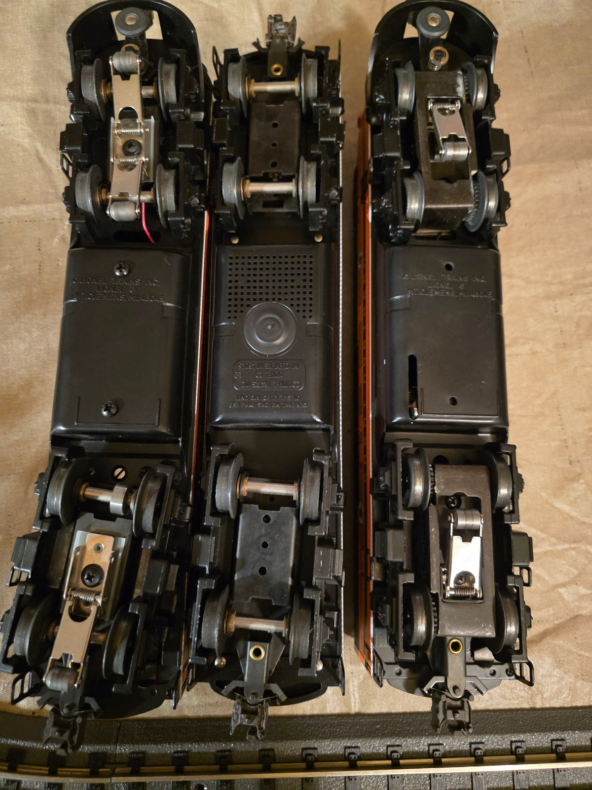 Lionel 6-11724 Great Northern F3 A-B-A diesel locomotive set, underside view of all three units showing trucks, wheels and couplers.