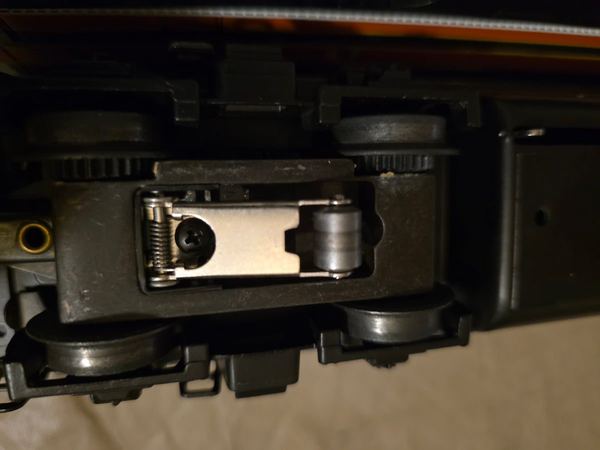 Lionel 6-11724 Great Northern F3 diesel locomotive, close-up underside view of a truck roller assembly and wheels.