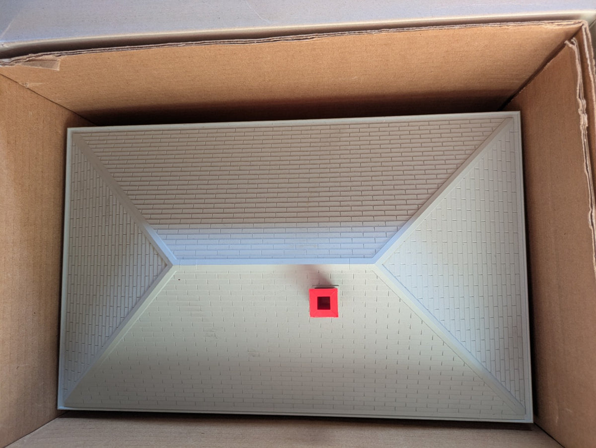 Lionel 6-14257 #133 Passenger Station top view showing the gray roof and red chimney inside the box