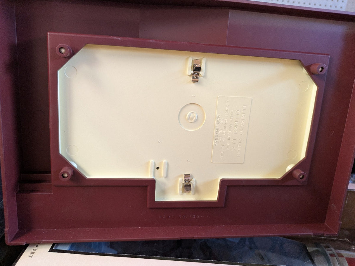 Lionel 6-14257 #133 Passenger Station underside showing the cream base plate and two electrical contact clips