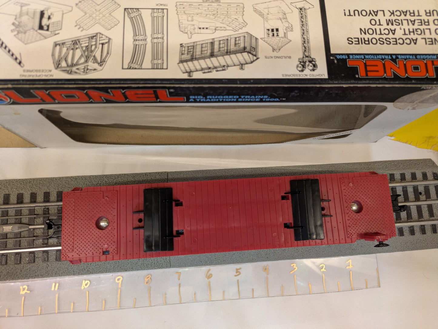 Top view of red Lionel 6-16330 flatcar showing trailer supports