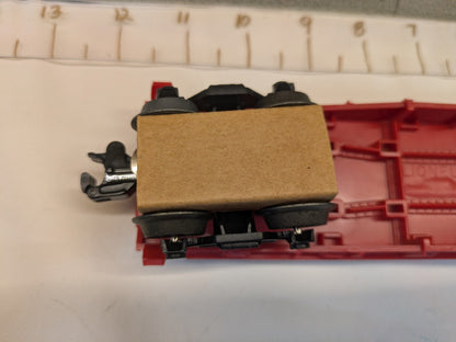 Underside close-up of truck and operating coupler on Lionel 6-16330 flatcar