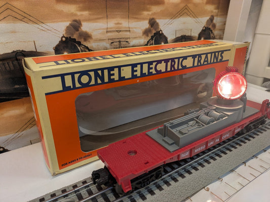 Lionel 6-16663 Missouri Pacific searchlight flatcar, red and gray, three-quarter view with illuminated searchlight and box