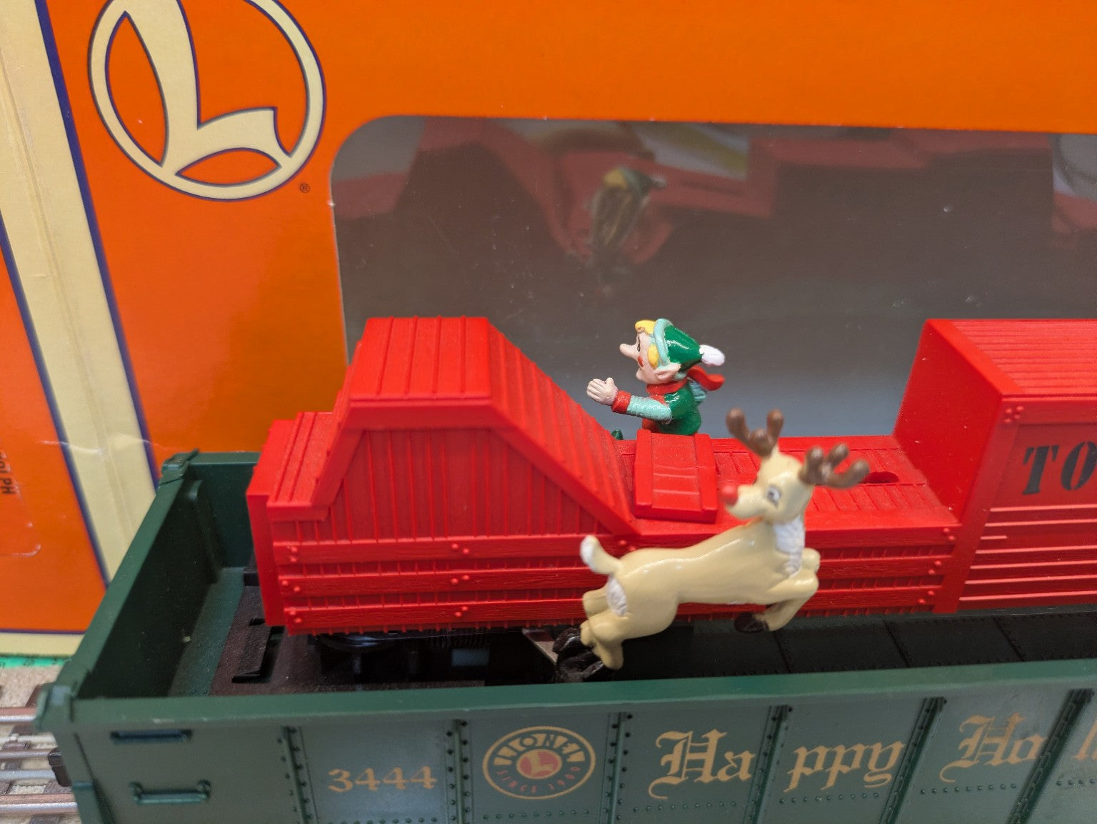 Lionel 6-16795 animated elf and Rudolph figures beside red toy crates in green gondola