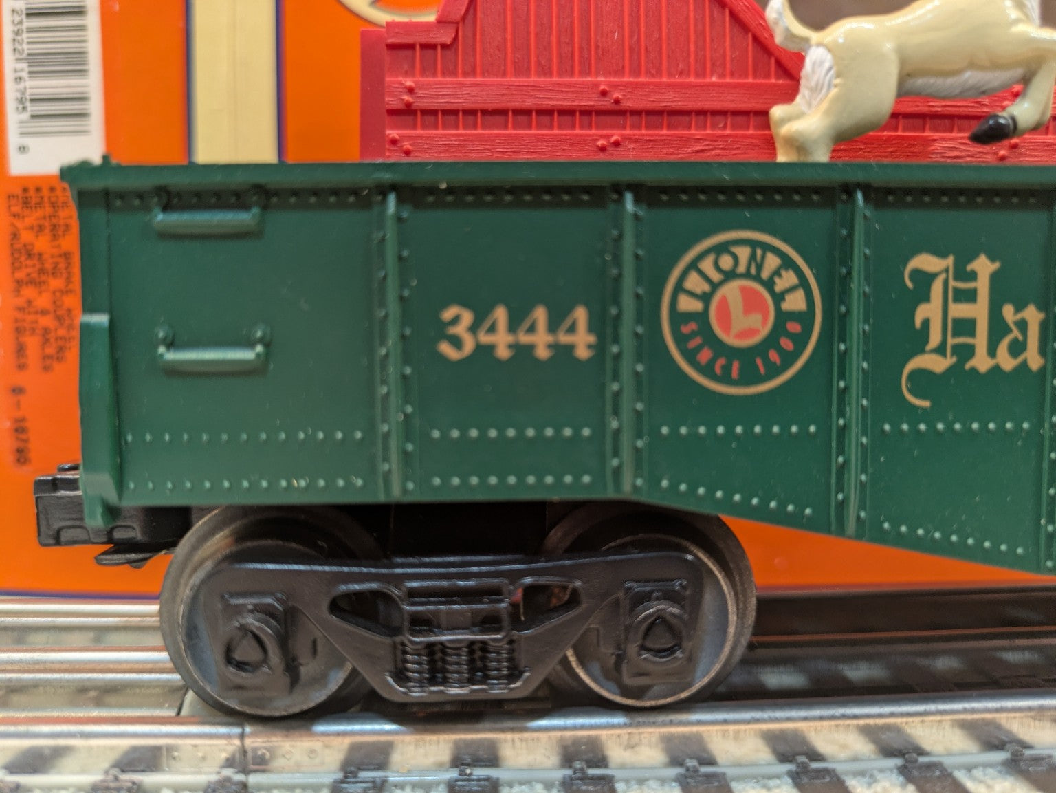 Lionel 6-16795 green gondola close-up showing gold road number 3444 and Lionel Since 1900 emblem
