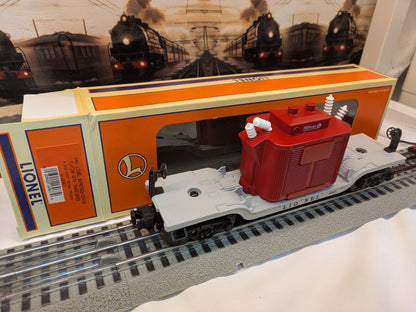 Lionel 6-16967 depressed-center flatcar with red transformer load, three-quarter view with Lionel box behind