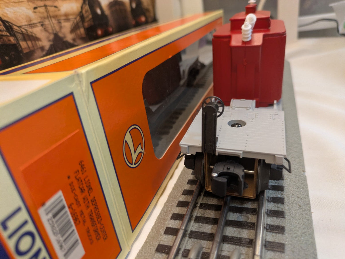 Lionel 6-16967 depressed-center flatcar with red transformer load, end and deck view beside Lionel box