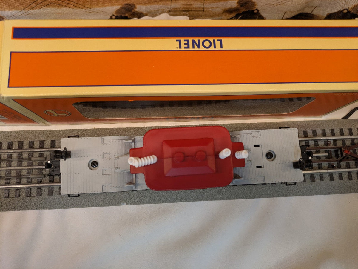 Lionel 6-16967 depressed-center flatcar with red transformer load, top view showing gray depressed-center deck