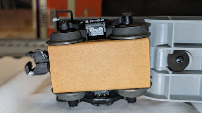 Lionel 6-16967 underside detail from opposite side showing truck, wheelsets, coupler, and cardboard packing block