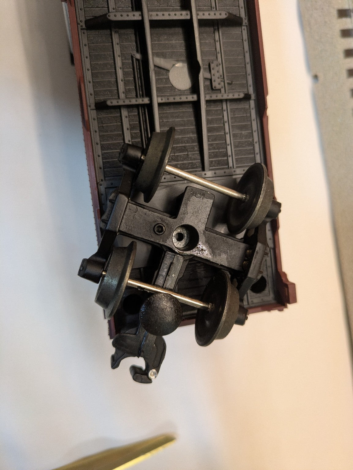 Lionel 6-17224 brown box car underside alternate view showing truck wheels and coupler