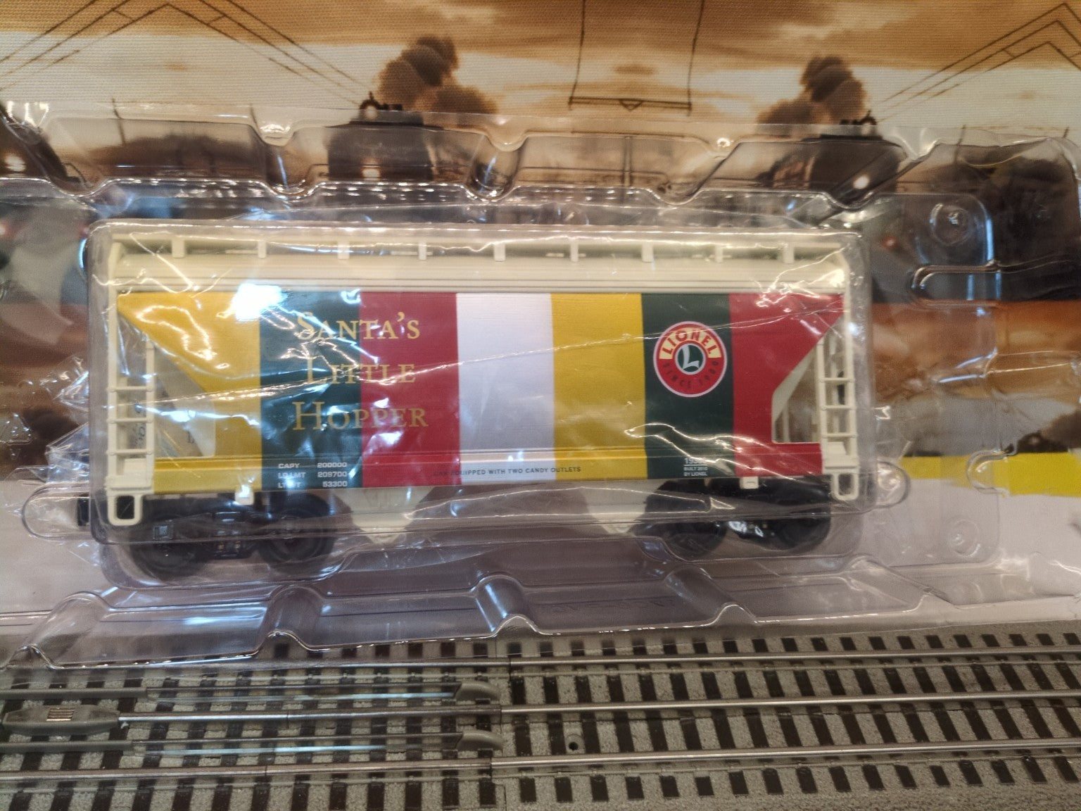 Lionel 6-19366 white, red, green, and gold Santa’s Little Hopper visible through clear inner packaging