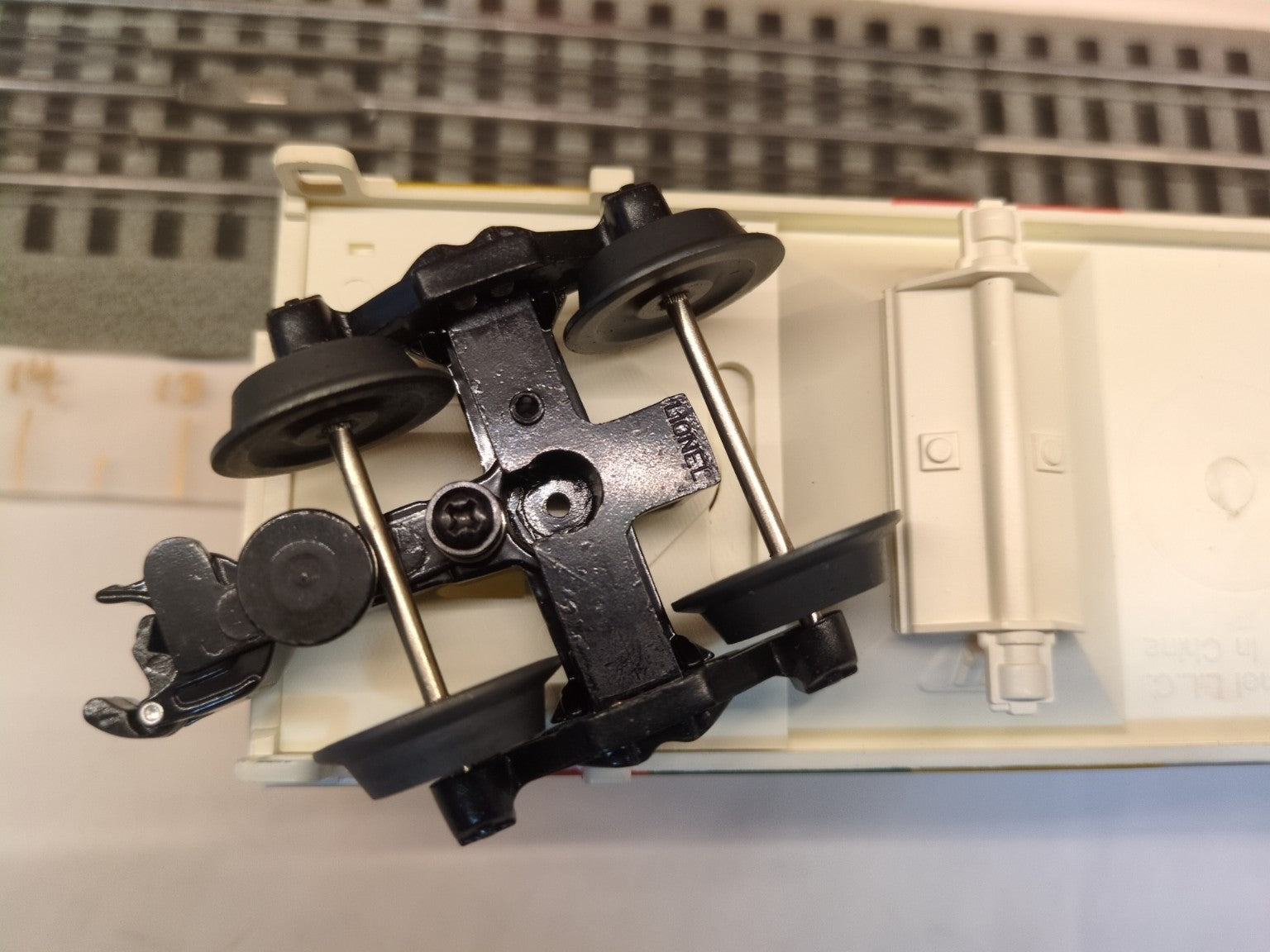 Lionel 6-19366 hopper underside close-up showing one black die-cast truck and coupler