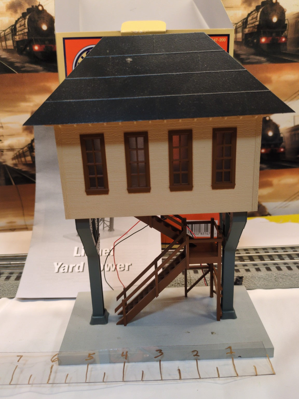 Lionel 6-83147 Yard Tower front view showing tan upper structure, black roof, brown windows and staircase