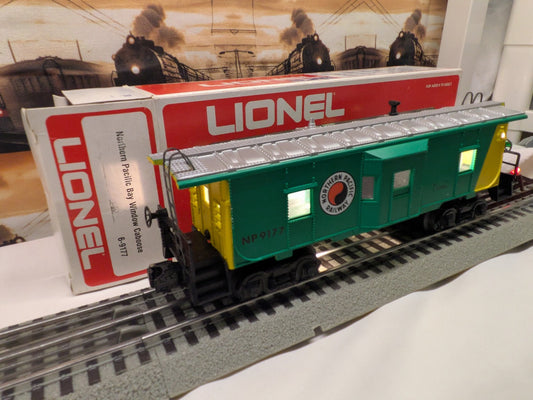 Lionel 6-9177 Northern Pacific bay-window caboose, three-quarter side view with green body, yellow ends and silver roof