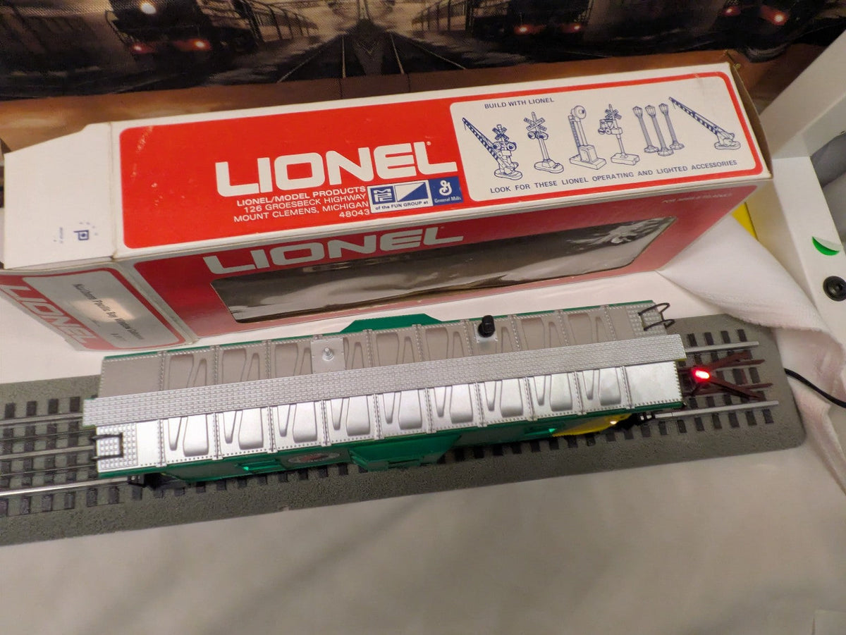 Lionel 6-9177 Northern Pacific bay-window caboose, elevated roof and side view with silver roof and green body