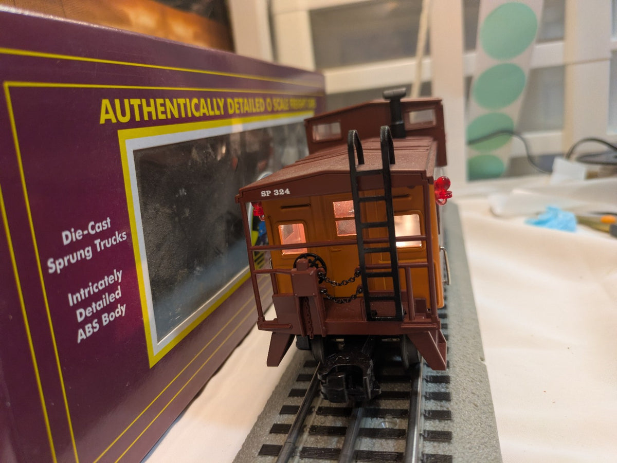 MTH Southern Pacific 324 caboose end view showing ladder railings red marker lights and illuminated windows