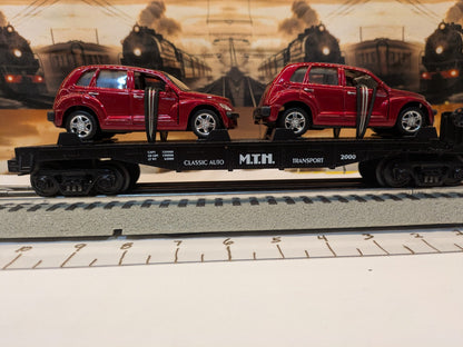 MTH 30-76039 black Auto Transportation flatcar with two red PT Cruisers, broadside view