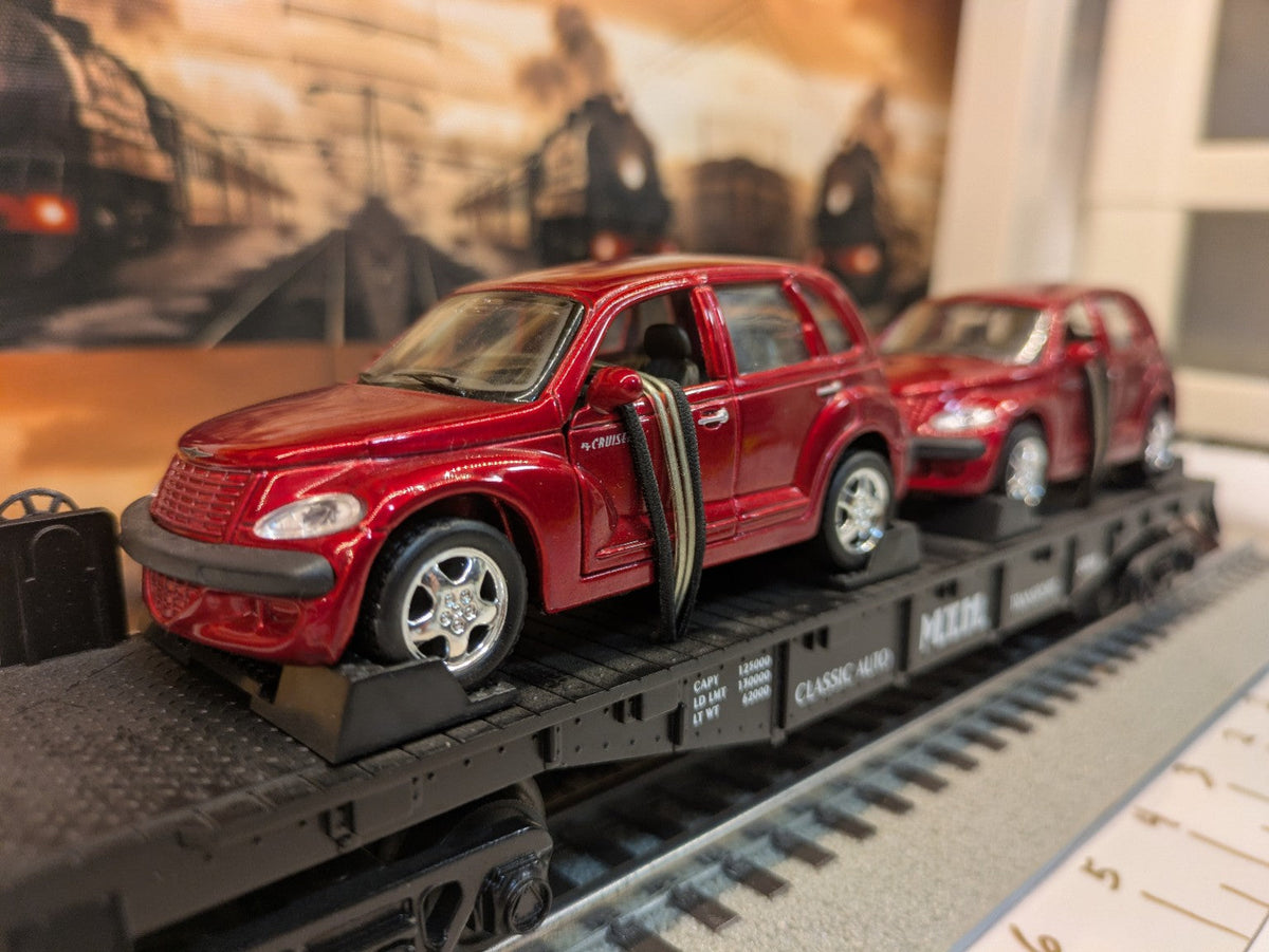 MTH 30-76039 black Auto Transportation flatcar with two red PT Cruisers, close three-quarter view