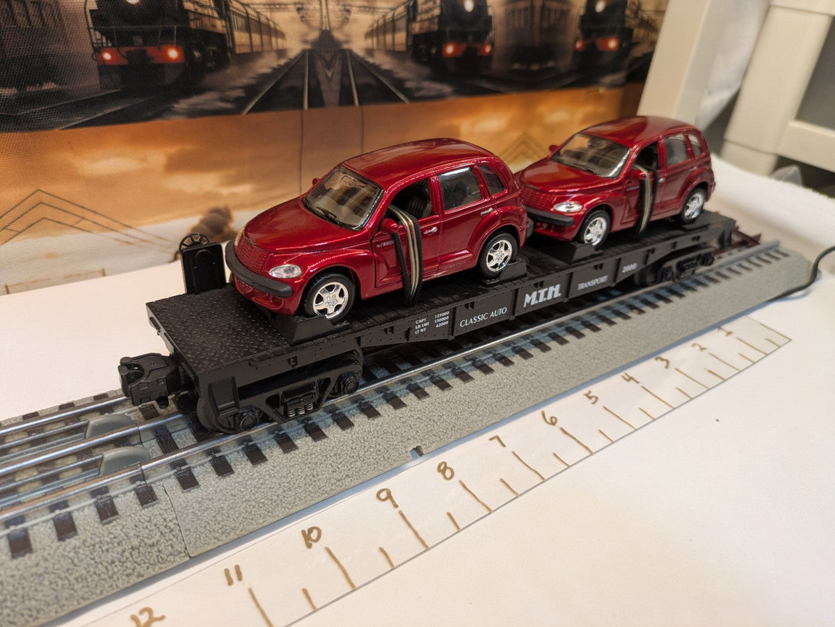 MTH 30-76039 black Auto Transportation flatcar with two red PT Cruisers, elevated complete view