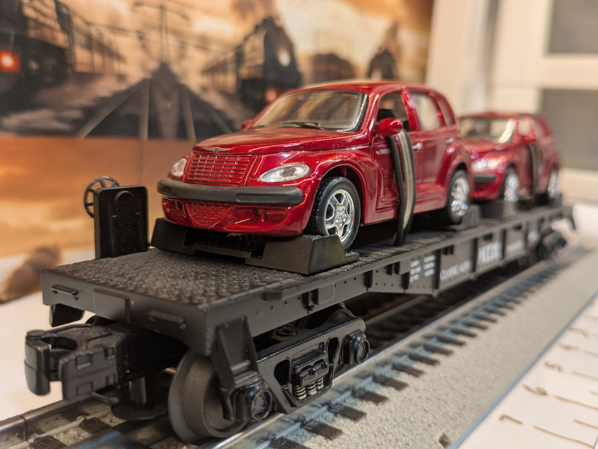 MTH 30-76039 black Auto Transportation flatcar with two red PT Cruisers, three-quarter view
