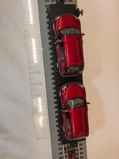 MTH 30-76039 black Auto Transportation flatcar with two red PT Cruisers, top view