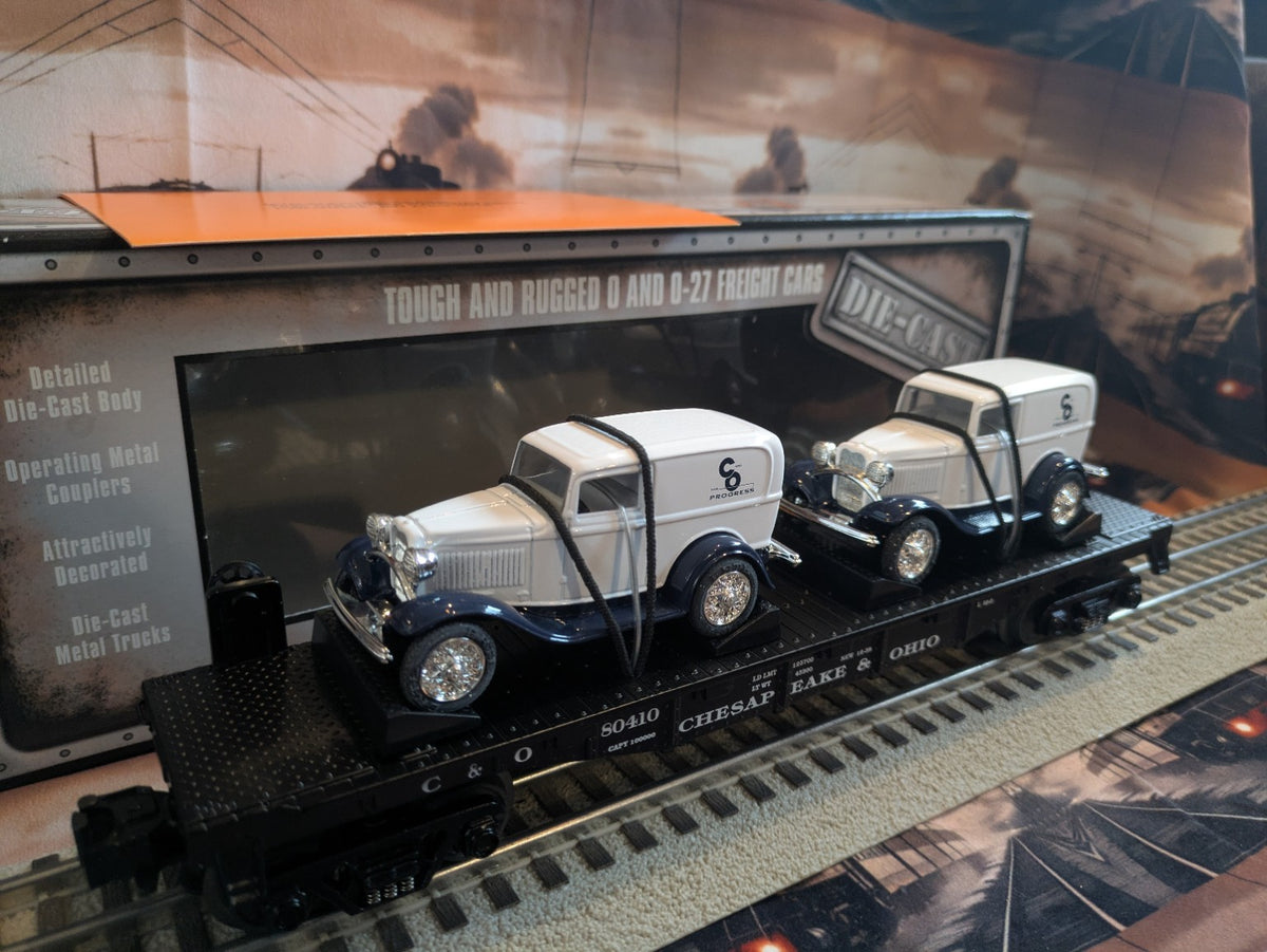 MTH 30-8304 Chesapeake & Ohio black flatcar with two white panel vans, three-quarter view