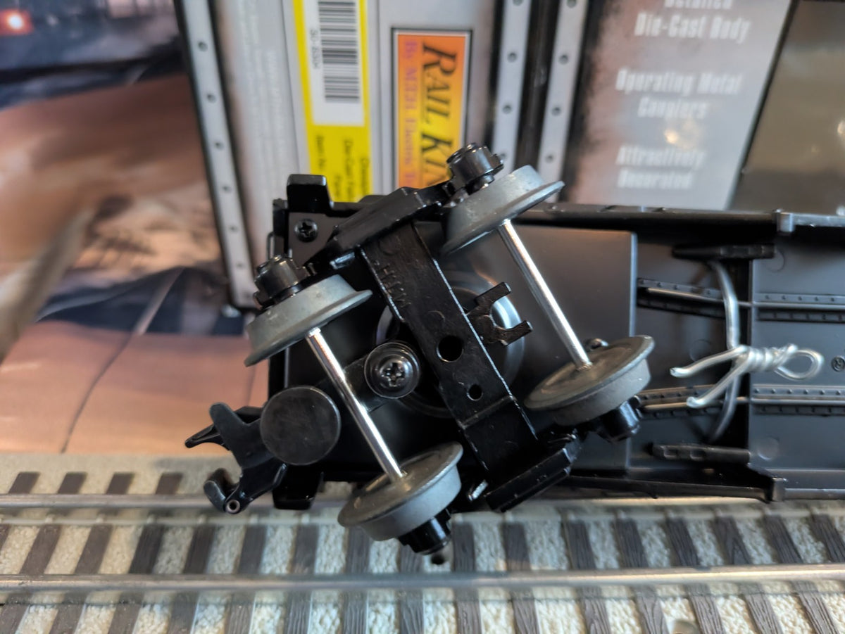 MTH 30-8304 black flatcar underside with metal trucks and coupler, opposite angled view
