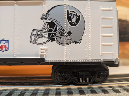 MTH Rail King 30-74265 Oakland Raiders boxcar, side close-up of Raiders helmet graphic, NFL shield and black truck