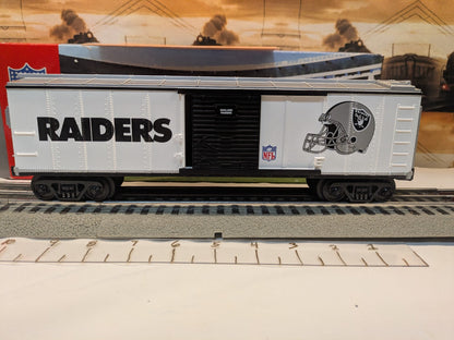 MTH Rail King 30-74265 Oakland Raiders boxcar, straight side view with Raiders lettering, black door and helmet graphic